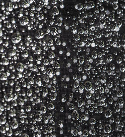 Full frame shot of drops on wet glass