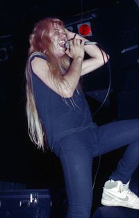 Young woman with arms raised at night