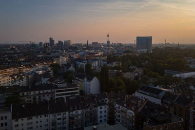 High angle view of buildings in city against sky during sunset