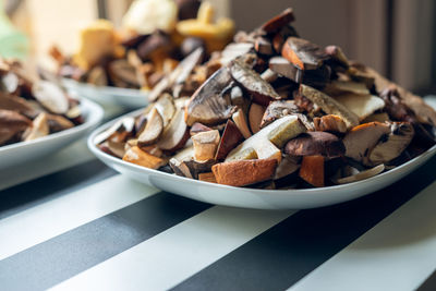 Plates full of cleaned, sliced, colored mushrooms. bay bolete, larch bolete, slippery jack, 