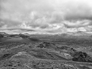 Scenic view of mountains against cloudy sky