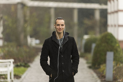 Portrait of smiling man standing outdoors