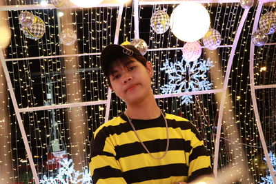 Portrait of boy looking at illuminated lights