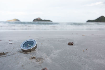 Close-up of navigational compass at beach