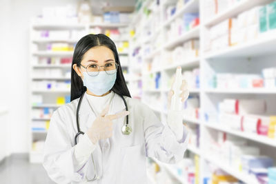 Portrait of pharmacist working in store