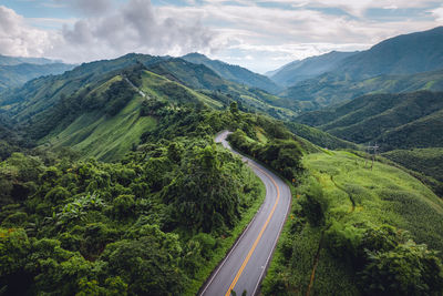 High angle view of road amidst mountains against sky