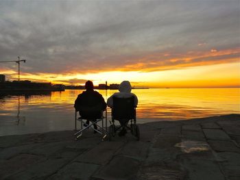 Pier on sea at sunset