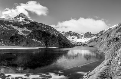 Scenic view of lake and mountains against sky during winter