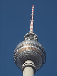 Low angle view of tower against blue sky