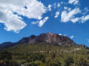 Low angle view of mountains against blue sky