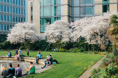 People relaxing at park in city