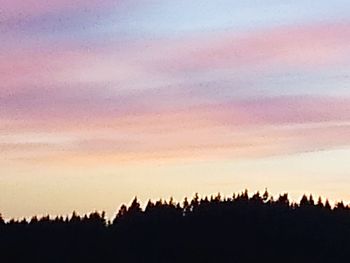 Silhouette landscape against sky during sunset