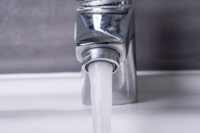 Close-up of faucet in bathroom