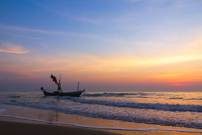 Silhouette boat on sea against sky during sunset