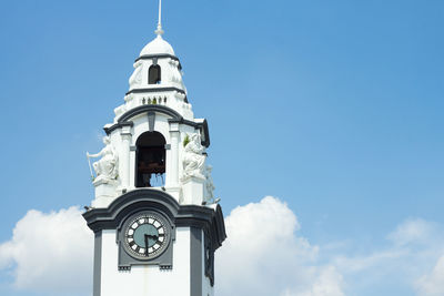 Low angle view of historic clock tower against sky