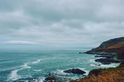 Scenic view of sea against storm clouds