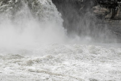 Scenic view of waterfall in sea
