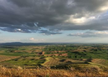 Scenic view of landscape against cloudy sky