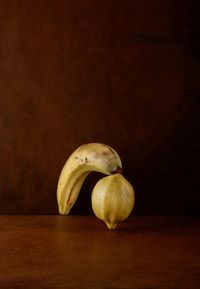 Close-up of fruits on table against black background