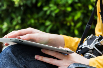 Midsection of man using mobile phone
