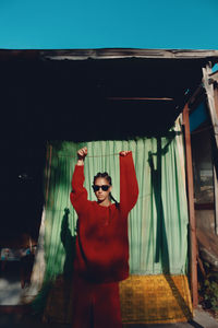 Low angle view of woman standing against building