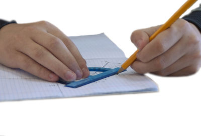 Midsection of man reading book on paper