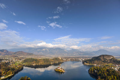 Scenic view of lake and mountains against blue sky