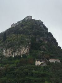 Old ruin building by mountain against sky