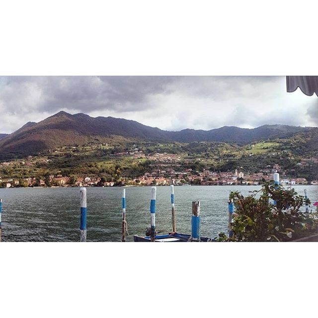 mountain, mountain range, water, sky, nautical vessel, cloud - sky, transfer print, sea, lake, transportation, cloud, river, scenics, boat, nature, mode of transport, building exterior, auto post production filter, built structure