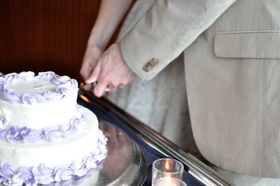 Couple cutting into wedding cake