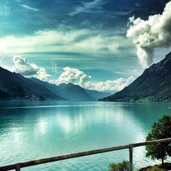 Scenic view of calm lake against cloudy sky