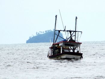 Ship in sea against clear sky