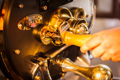 Cropped hand of person holding machine