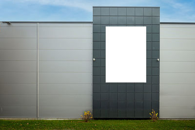 Blank white billboard for advertisement on the facade of building, outdoor advertising mockup