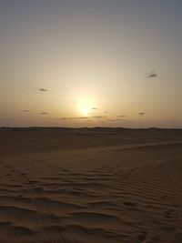 Scenic view of beach against sky during sunset