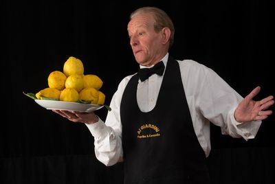 Man holding apple over black background