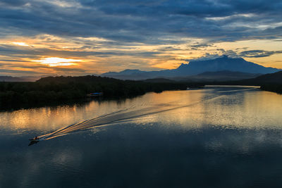 Scenic view of lake against sky during sunset