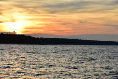 Scenic view of sea against orange sky