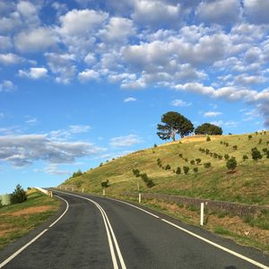 Road passing through landscape against sky