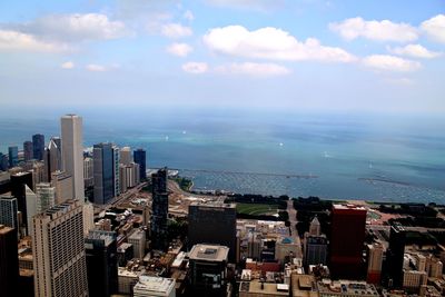 High angle view of buildings by sea against sky