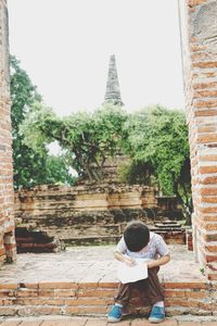 Full length of man outside temple against building