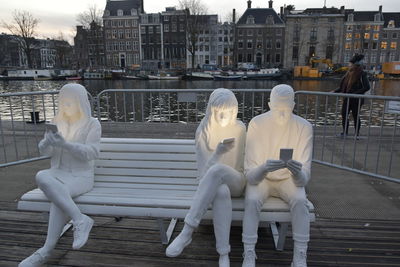 Statue against buildings in city