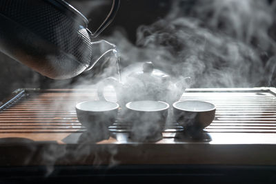 Close-up of burning candles on table