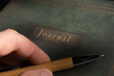 Close-up of hand holding book