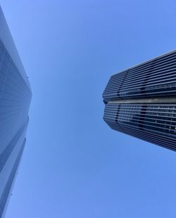 Low angle view of modern building against clear blue sky