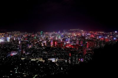 High angle view of illuminated city buildings at night