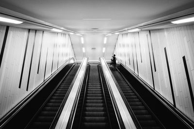 Low angle view of person on escalator in subway station