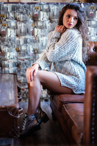 Portrait of young woman sitting outdoors