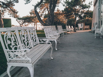 Empty chairs and table in park