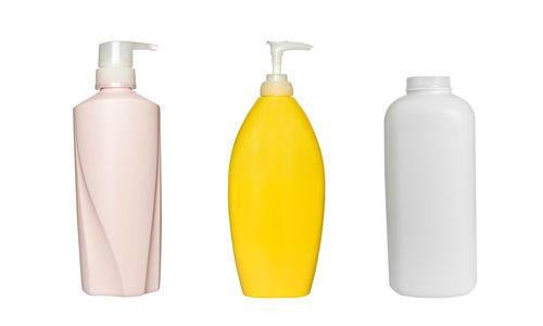 Close-up of empty bottles against white background